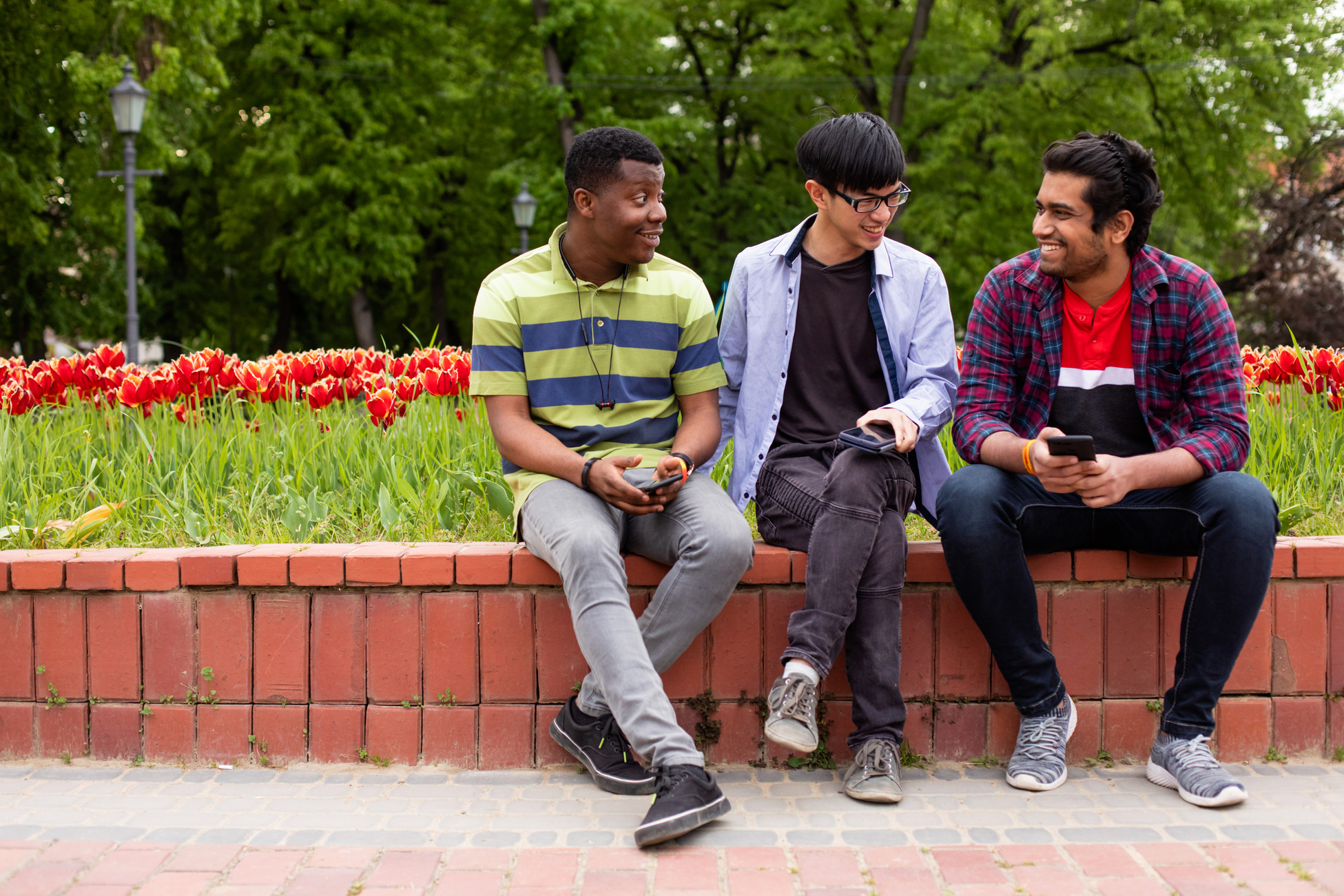 Three Young Men Meeting during Break between College Lectures
